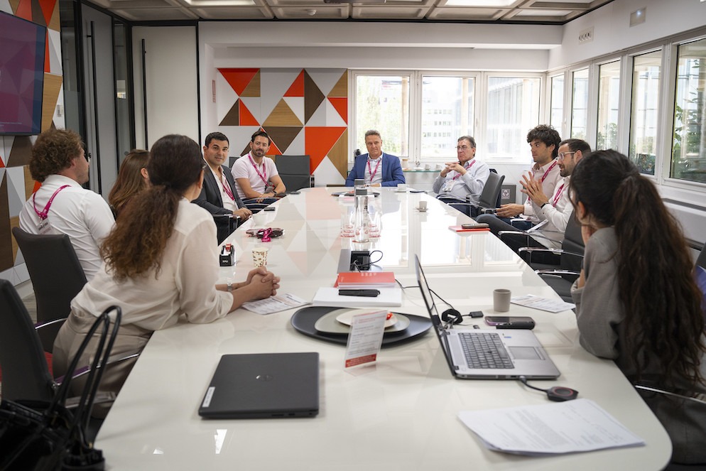 A group of iGaming professionals engaged in a high-level discussion in a boardroom setting during the 2025 Gaming in Spain Conference.