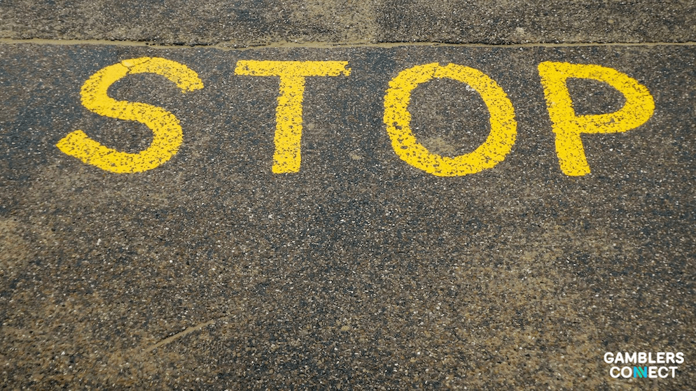 A stop sign painted on the ground, representing the ACMA's ongoing efforts to halt the spread of illegal offshore gambling platforms in Australia.
