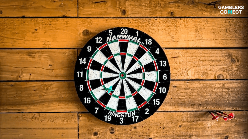 A dart in the bullseye of a dartboard, symbolizing the long-term partnership between Betfred and the PDC for the World Matchplay tournament.