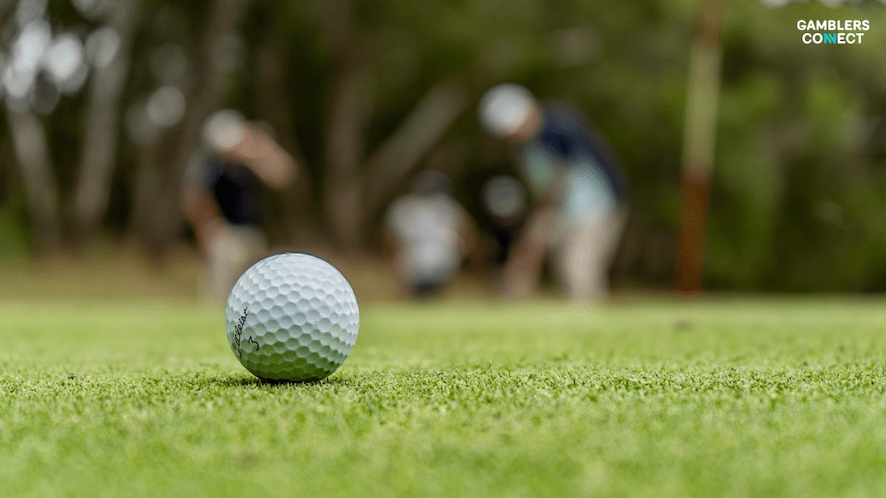 A close-up of a golf ball on a putting green, representing the golf analytics and betting tools offered by the newly combined Betsperts Golf and Fantasy National platform.