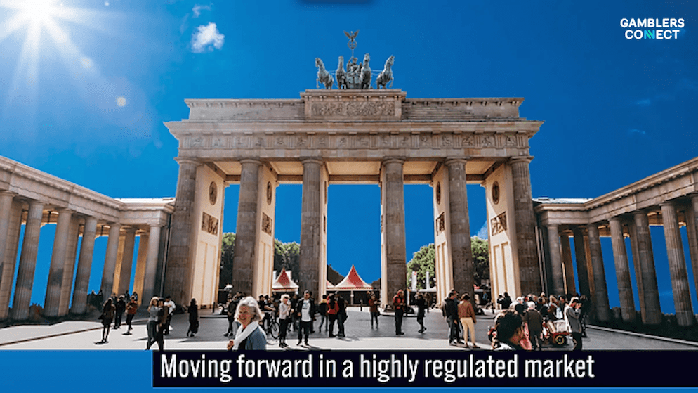 An image of Berlin's Brandenburg Gate with the text 'Moving forward in a highly regulated market,' symbolizing the key themes of the Gaming in Germany Conference.