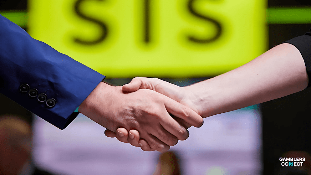 Two people shaking hands to finalize the long-term rights agreement between SIS and Doncaster Greyhound Stadium, ensuring the delivery of racing content until 2028.
