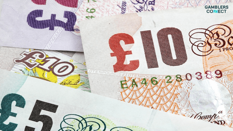 British Pound Sterling banknotes, illustrating the funding from the new statutory RET levy that will support UK gambling harms charities like GambleAware.