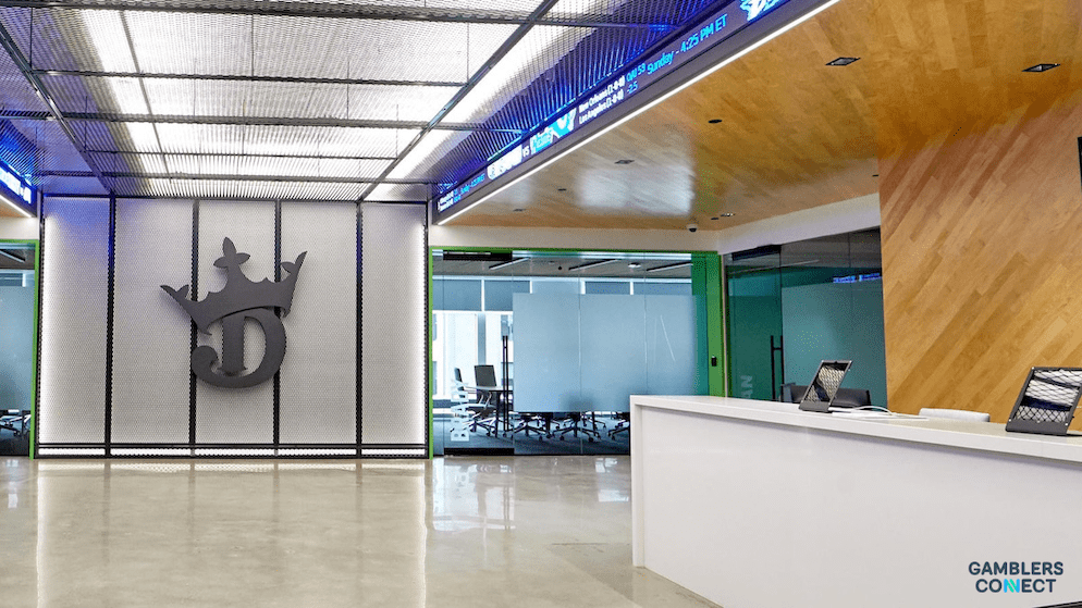 A close-up of the DraftKings brand logo inside their corporate office, representing the operator's significant Q2 2025 profitability and leadership in the North American market.
