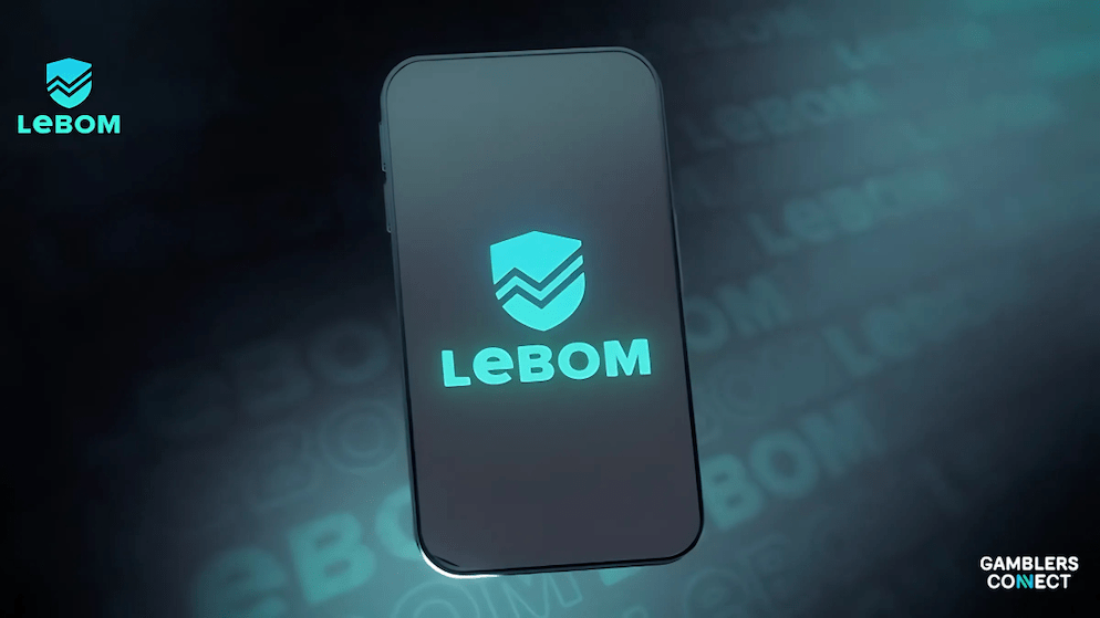 A focused view of a smartphone screen displaying the Lebom app logo in teal, set against a dark and slightly blurred background that includes the app's name, emphasizing the digital platform.