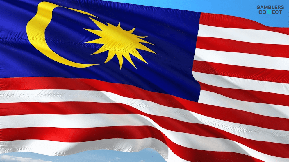 The flag of Malaysia waving, symbolizing the nation's coordinated effort to combat online gambling, fraud, and other harmful content.