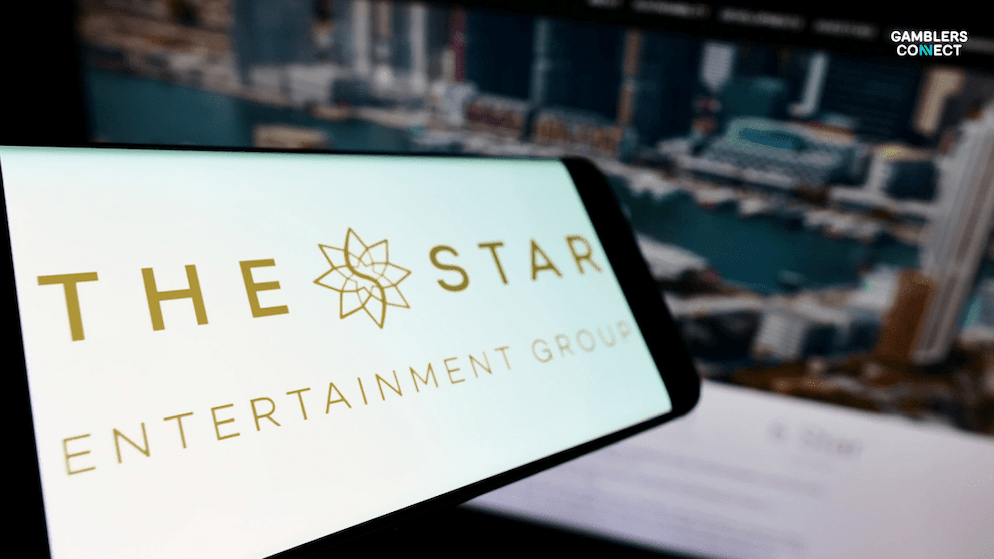 A close-up shot of a smartphone screen displaying the elegant "THE STAR ENTERTAINMENT GROUP" logo, with a blurred cityscape or casino background, symbolizing the company's financial results and brand presence. The "Gamblers Connect" logo is in the top left corner.