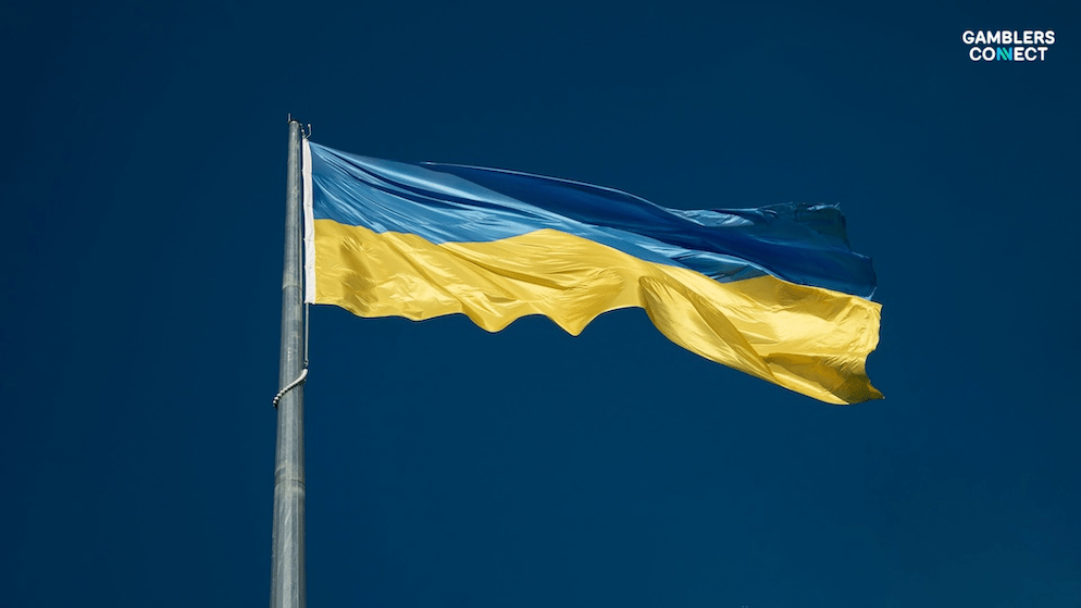 The Ukrainian flag represents the government's increased oversight and control over the iGaming sector through a mandatory transaction monitoring system to ensure transparency.