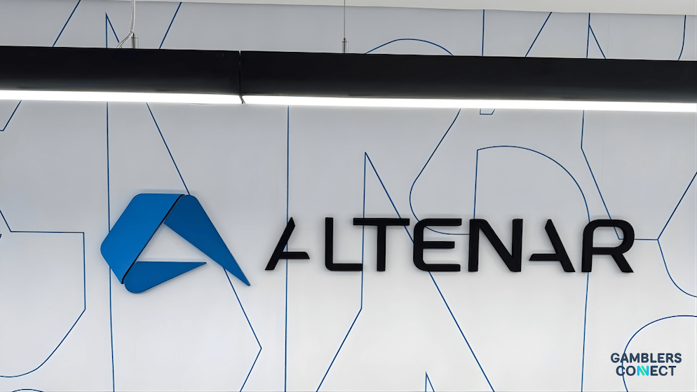 The blue and black Altenar company logo prominently displayed on a modern office wall with geometric line patterns.