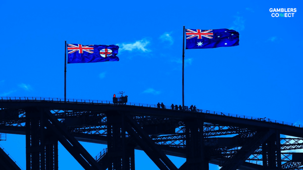 The Australian flag against a clear blue sky, symbolizing the national scope of the BetStop self-exclusion register and its impact on responsible gambling across the country.
