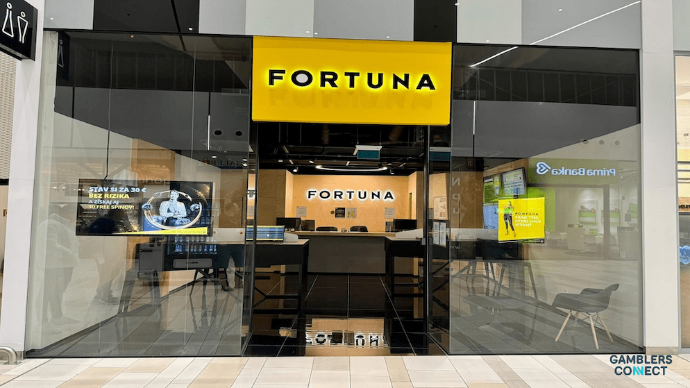 An interior view looking out from a sleek, contemporary Fortuna retail location, which reflects the company's modern approach to the betting and gaming industry.