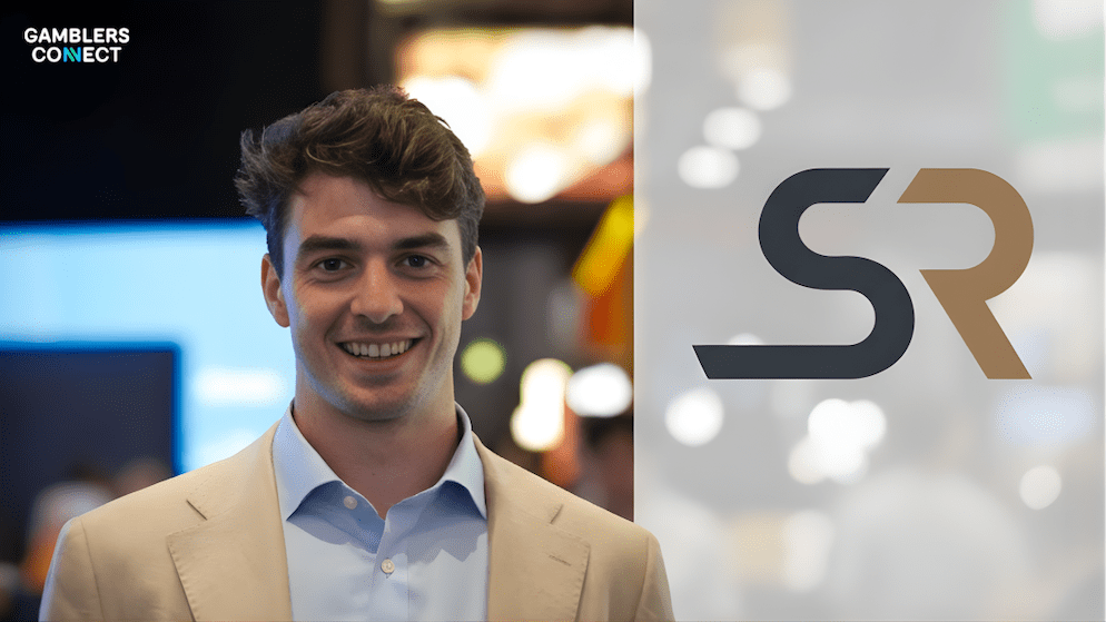 Professional portrait of Joe Adair smiling, emphasizing his experience in product, trading, and commercial roles vital for Sporting Risk's data-driven betting portfolio expansion.