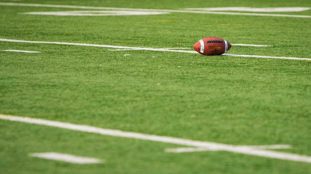 A football field depicting the NFL and the long-asked question whether it is rigged
