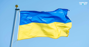 The vibrant blue and yellow flag of Ukraine flying against a clear sky, symbolizing the nation's efforts to develop a new state-run self-exclusion register for gamblers.