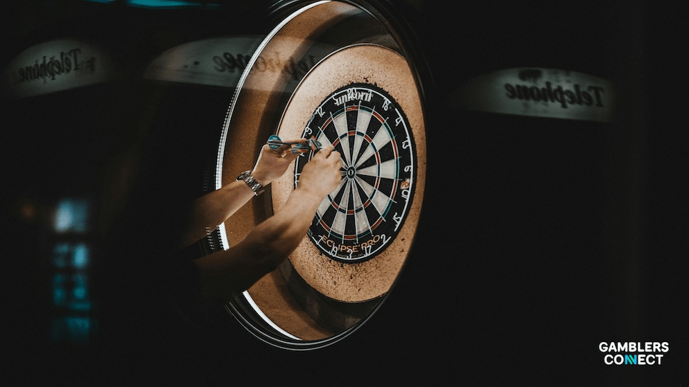 A dartboard with darts embedded in the bullseye, illustrating the surge in wagering activity on major tournaments like the PDC World Darts Championship.