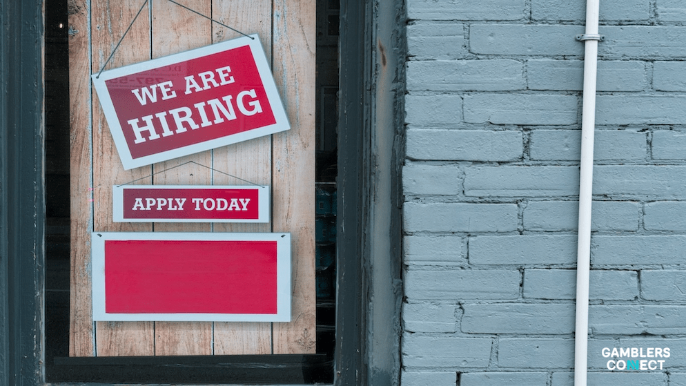 Official announcement graphic showing Dimokratis Papadimos, the new Director of Account Management at iGaming developer enjoy GAMING, wearing a suit and tie against a branded blue background.