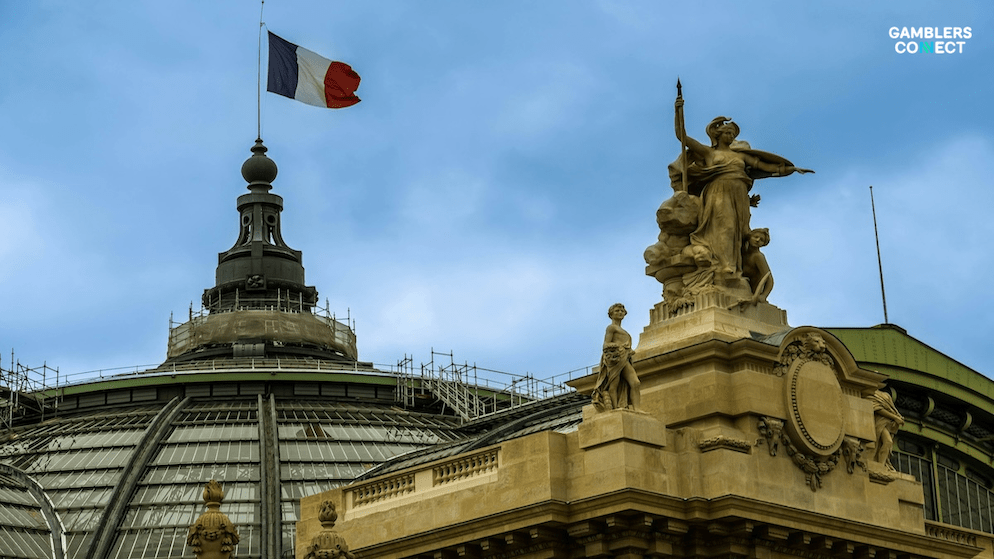 A historic French building with the national flag, symbolizing the regulatory framework implementing tighter identity verification for player protection and the France Self-Exclusion system.