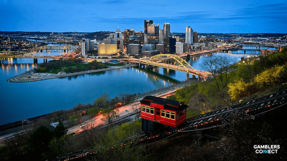 The Pittsburgh city lights at night, symbolizing the vibrant growth of Pennsylvania's land-based and online gaming sectors.