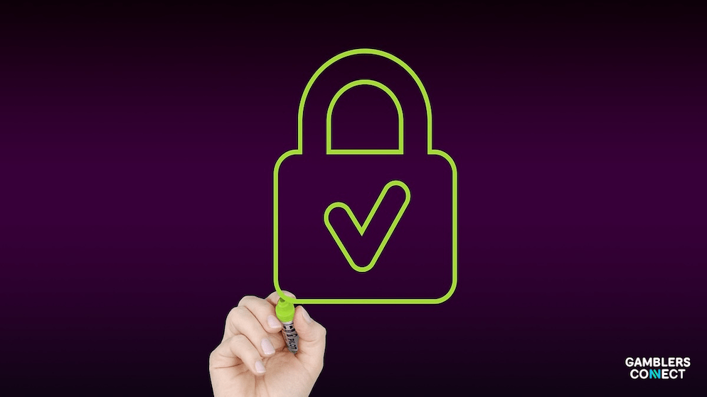 A hand outlining a green padlock with a checkmark, representing BetBlocker's commitment to harm prevention and secure access management for online gambling - BetBlocker App Dashboard.