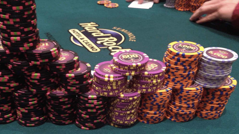A large stack of poker chips, including high-denomination chips, on a poker table at the Hard Rock Seminole Hotel & Casino.