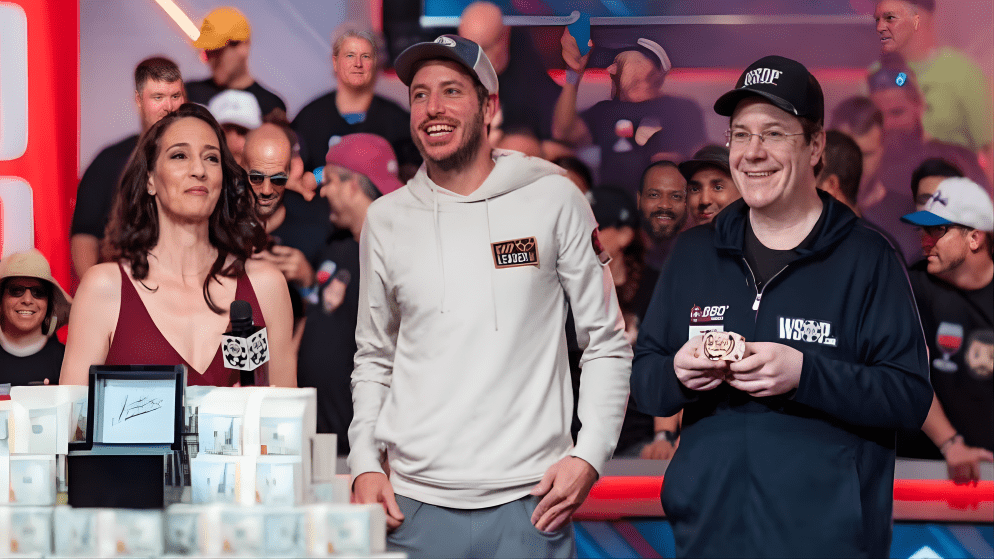 Jamie Gold (right) with the WSOP trophy/chip, standing next to other prominent poker figures like Chris Moneymaker.
