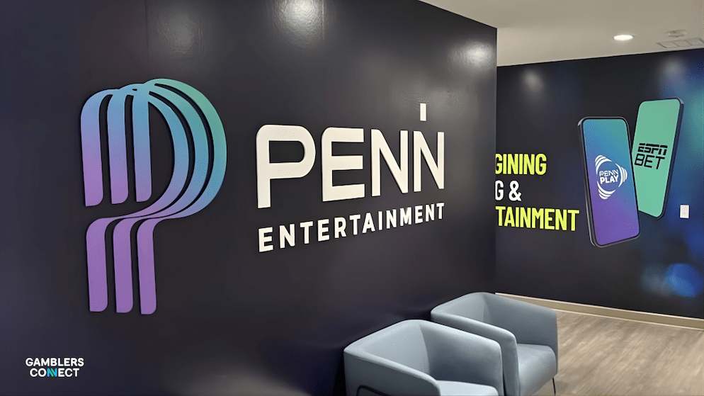 Wall branding inside Penn Entertainment, showing the logo and graphics representing Penn Play and ESPN BET apps, symbolizing their digital shift.