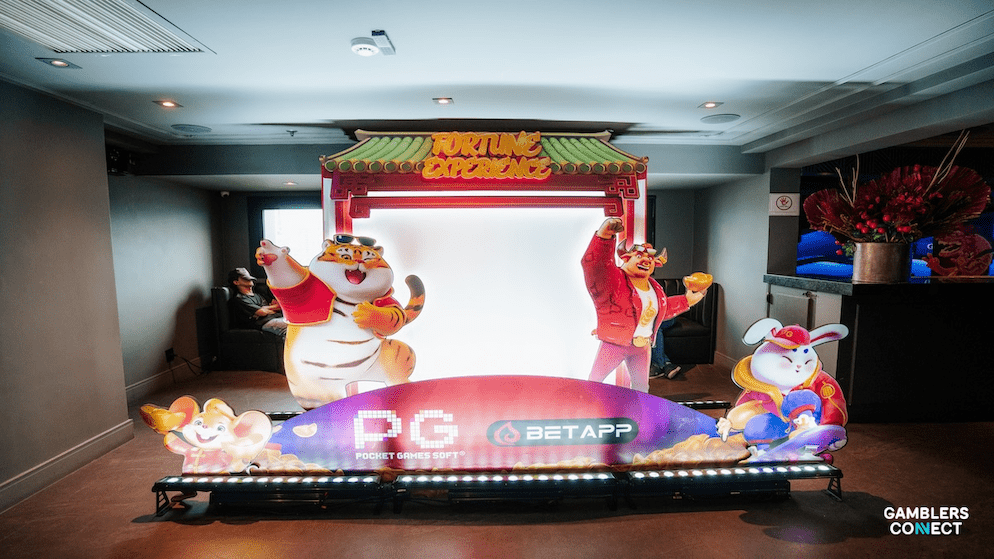 A PG Soft spokesperson speaking at a podium on a brick background, symbolizing corporate communication on integrity.