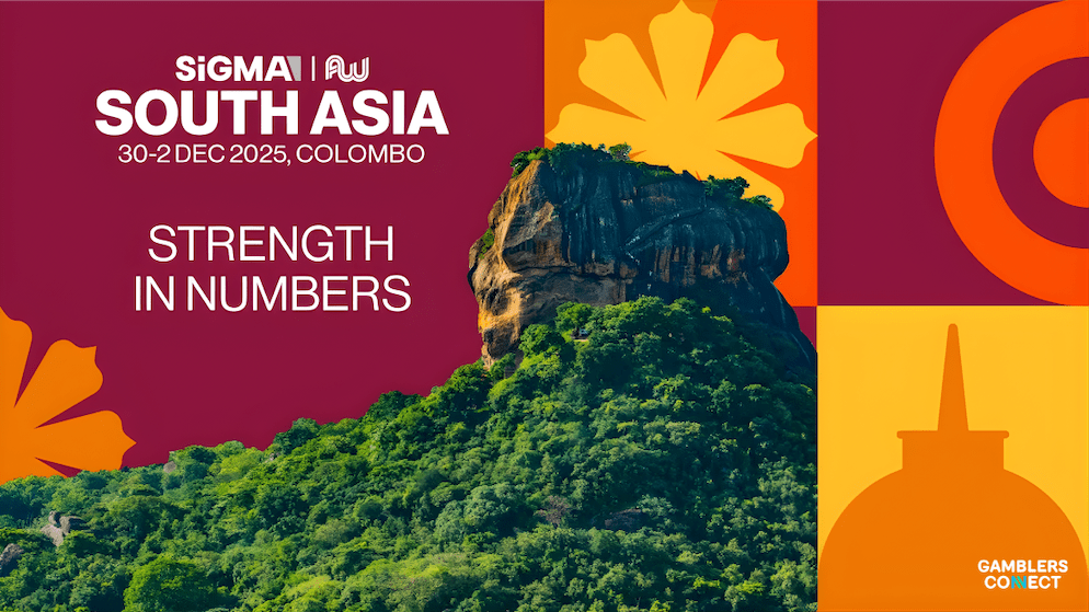 A bustling conference exhibition floor with attendees and exhibitors networking at gaming technology booths.