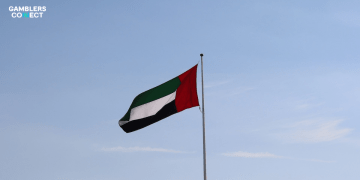 An editorial illustration featuring the UAE flag alongside digital gaming symbols and the Play971 logo, symbolizing the new license.