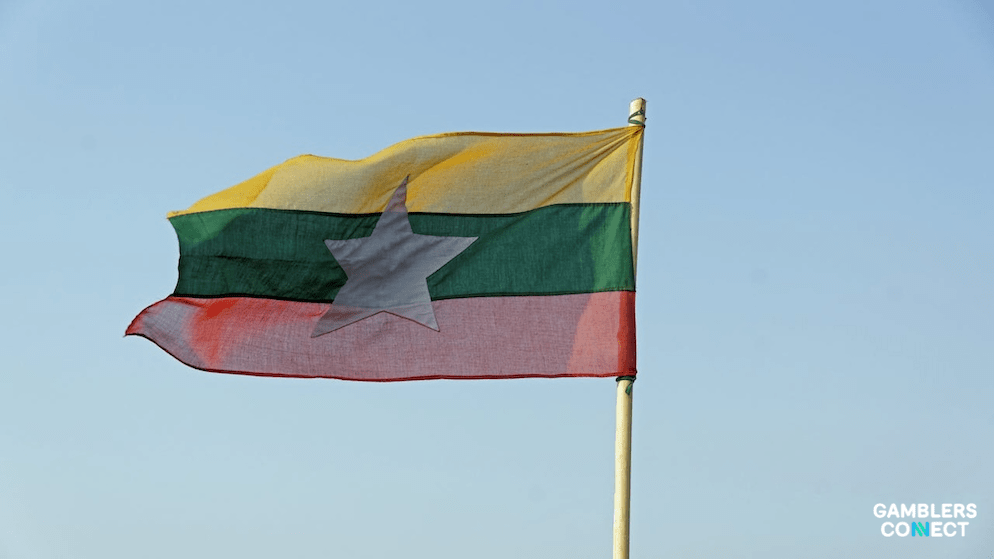 A view of the Myanmar flag waving, representing the government's reclaiming of territory in the Myawaddy–Maethawtalay area from criminal syndicates.