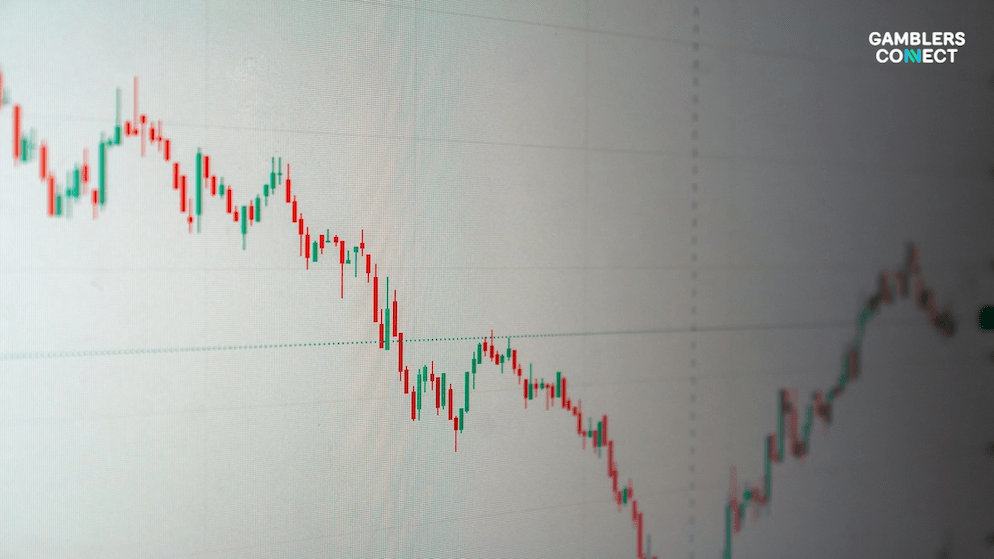 Close-up of a stock market graph showing a downward trend, representing the 20% revenue drop Ainsworth faces in the North American region.