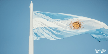 The national flag of Argentina waving against a clear blue sky representing the country's leadership in crypto adoption.