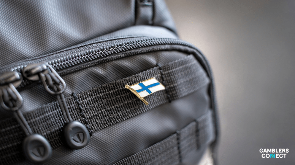 A detail shot of a Finland flag pin on gear, symbolizing the new "channelling" strategy aimed at bringing Finnish players from offshore sites to a regulated domestic market.