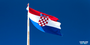 The national flag of Croatia waving against a clear blue sky, symbolizing Gaming Realms' latest market entry in partnership with Fortuna Entertainment Group.