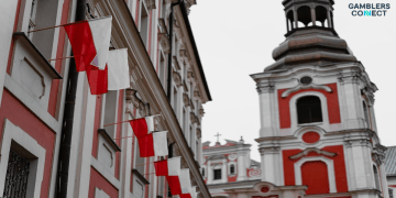 The exterior of the Sejm building in Warsaw, Poland, with the Polish flag flying in the foreground, representing the legislative crackdown.