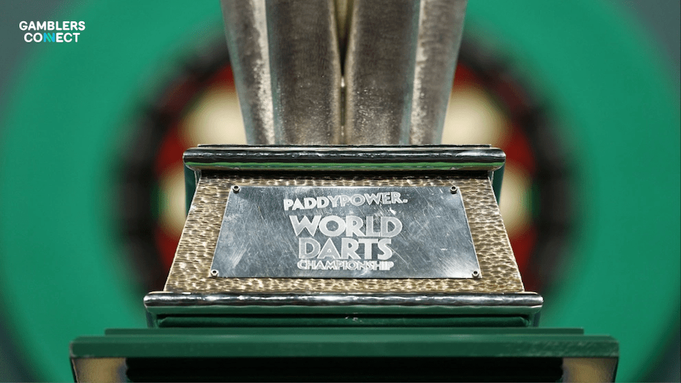 Professional darts player Ryan Searle competing on stage, highlighting the donation made to the Cure ADOA Foundation in his honor.