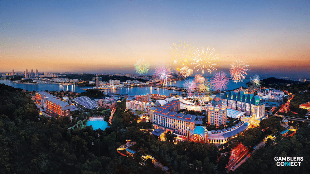 A panoramic night shot of the illuminated attractions at Resorts World Sentosa, highlighting the resort's shift towards non-gaming, lifestyle, and family entertainment.
