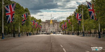 The Mall in London lined with Union Jack flags leading to Buckingham Palace, representing the UK government and the Gambling Commission's leaked plans for fee increases.