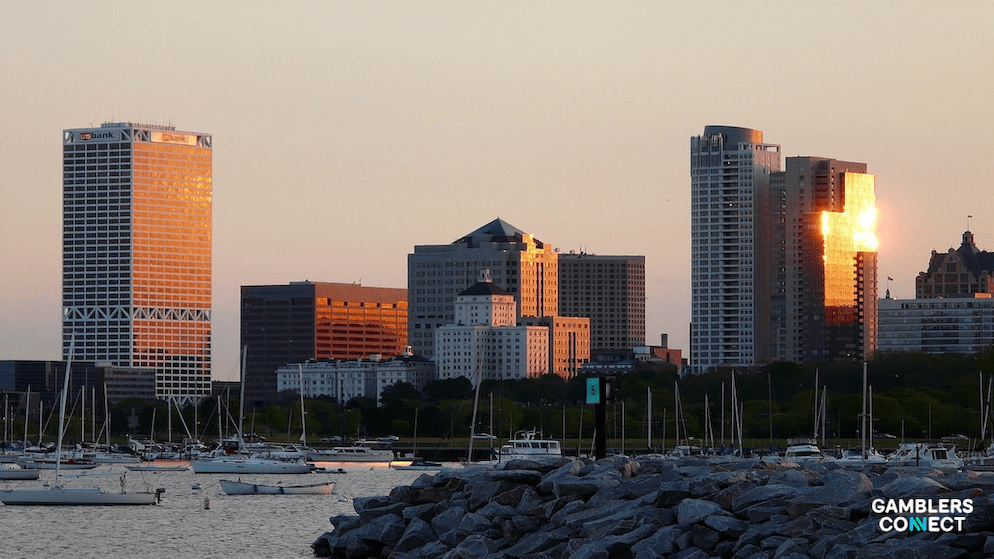 Hands holding pens over a document symbolizing the drafting of Assembly Bill 601 for tribal controlled sports betting.