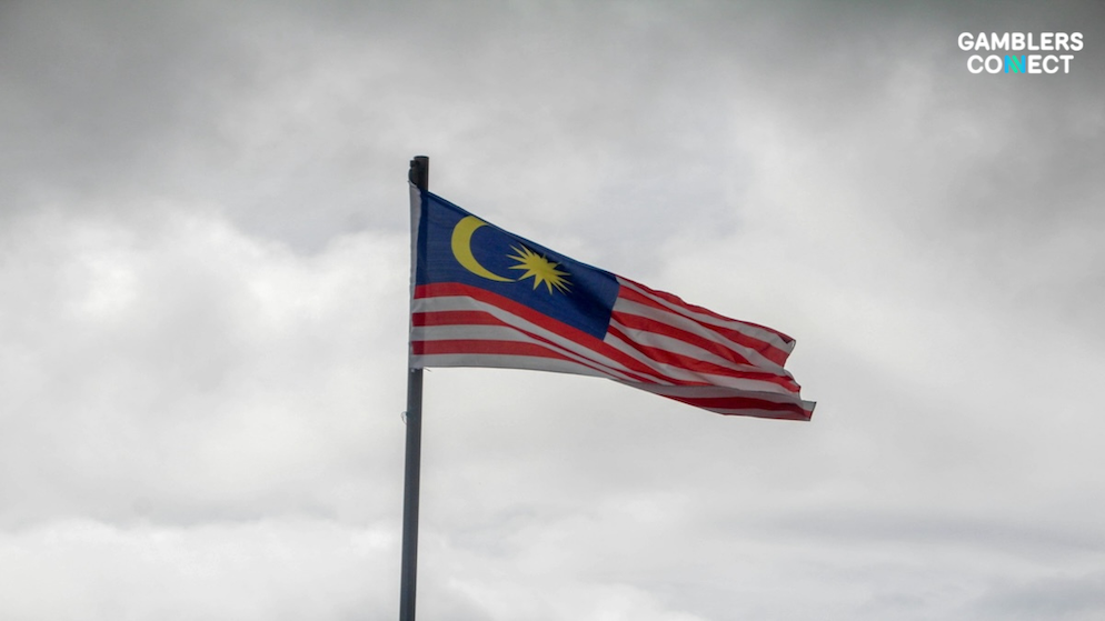 A close-up of the Malaysian flag, representing the collaboration between police and the MCMC to block over 5,000 illegal gambling websites.