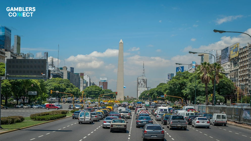 The flag of Argentina waving against a blue sky, used to symbolize national regulatory shifts.