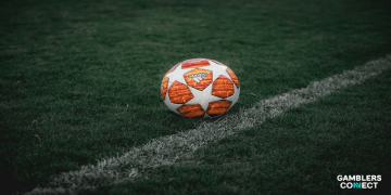 An orange Adidas ball used in the Champions League