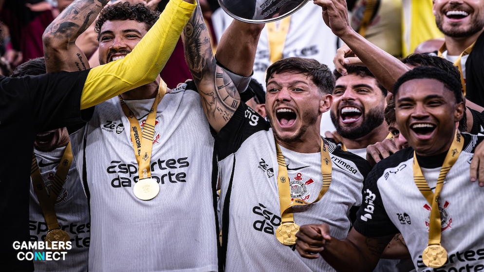 Close-up of Corinthians athletes with gold medals, showcasing the master sponsorship during a championship ceremony.