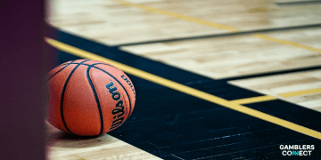 An official Wilson NBA basketball on a professional hardwood court, illustrating the standard size 7 official NBA basketball size.