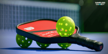 A high-performance red Wilson paddle resting on a court, representing the best pickleball paddles 2025 for advanced play.