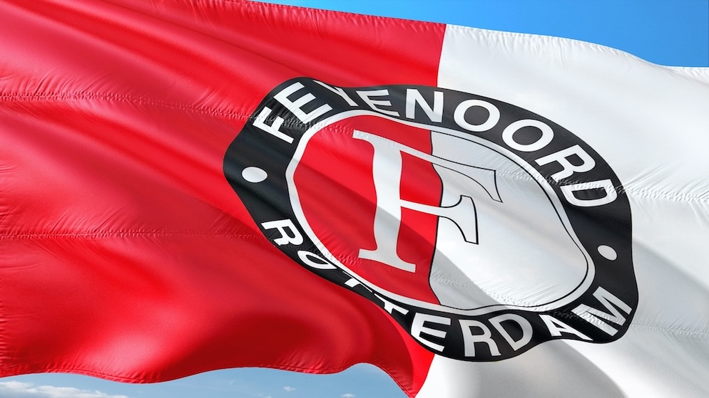 A red and white Feyenoord flag with the central "F" crest, illustrating Raheem Sterling's short-term loan under Robin van Persie.