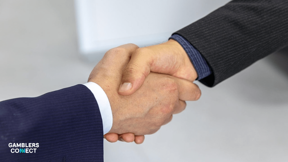 Various silver coins and sports data icons representing betting revenue and hubs and the partnership between Acquire.bet and E2.