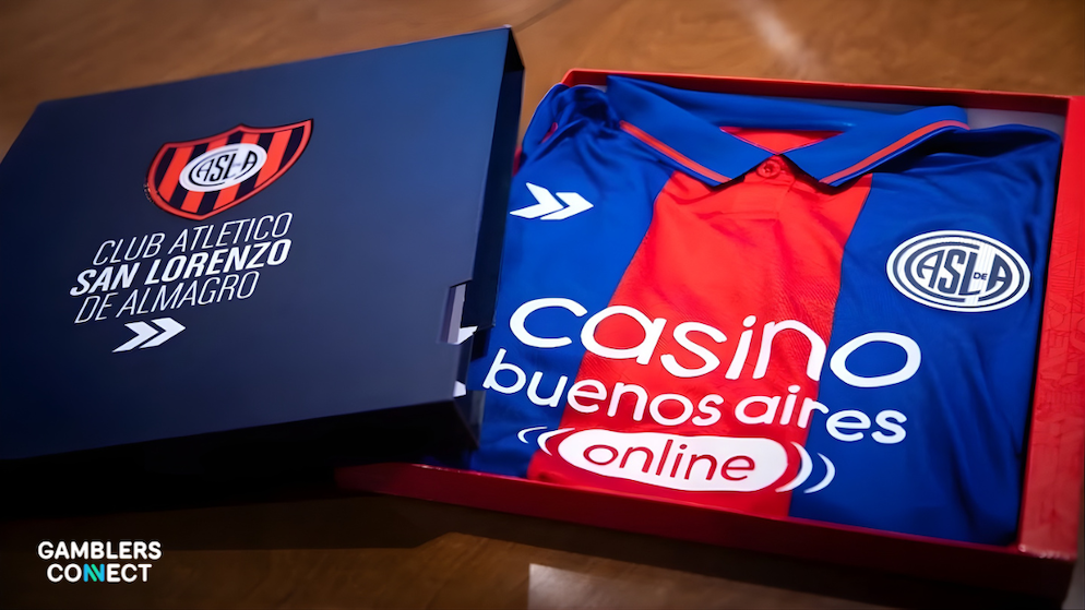 A premium blue presentation box containing a folded San Lorenzo (ASLA) football jersey with the Casino Buenos Aires Online logo visible.