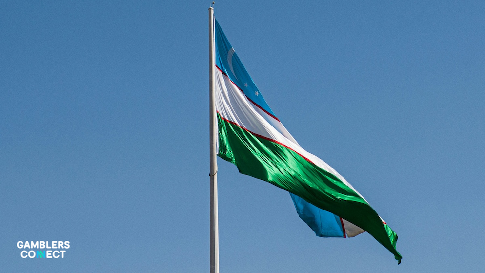 A flag of Uzbekistan waving, representing the country's cautious approach to its new online betting sector.
