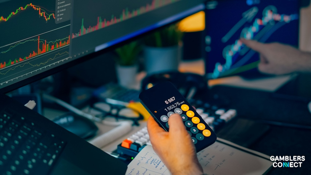 Financial charts on a screen with a person pointing at a specific upward trend in a dark, high-tech trading environment and the Bubblemaps analysis.